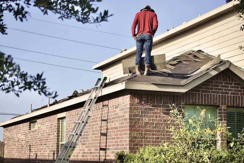 Professional roofer working on a residential roof in Morgantown